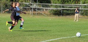 Julia Quinn drives home her first goal despite close guarding by Emily Baker