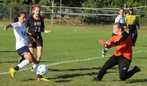 NYA goalie Scout Fischman tries to stop Anna Manahor