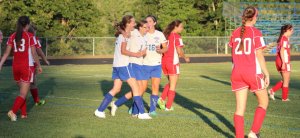 Megan Boos, Kaylyn Jordan, and Lauren Jakobs celebrate first goal