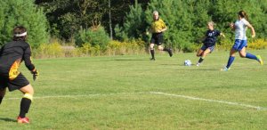 Sophomore Kate Marshall lines up a shot on GK Isabel Scribner