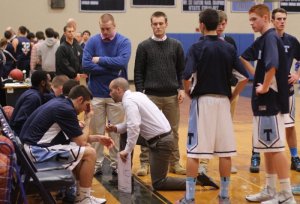 Ellsworth Rogers (blue sweater) watches