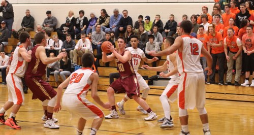Dan Baribeault (14 points) surrounded by Tigers