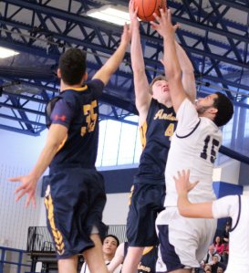 Jonathan Rodriguez (#35), EJ Perry (#4), and Andy Henriquez (#15) battle for a rebound