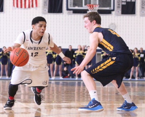 Julio Vicente (20 points) drives on EJ Perry (22 points)