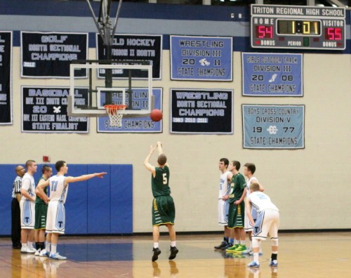 Adam Goldstein (on the right) converted a rebound off a missed free throw to give North Reading a  58-54 lead in the last minute
