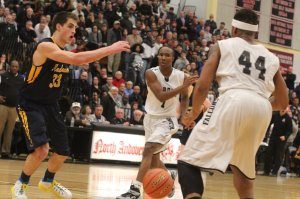 Isaiah McLeod passes to teammate Tevin Charles as Connor Merinder defends