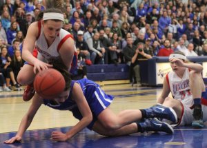 Jackie Luckhardt (nine assists) flies over Meg Knollmeyer