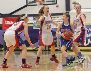 Kelly Arsenault hemmed in by a trio of Lancers