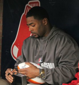 Malcolm signs a football