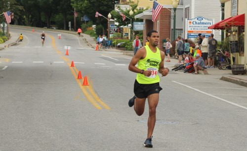 Winner Andrew Stewart leads the way past the Bridgton News office with second-place Silas Eastman in the distance