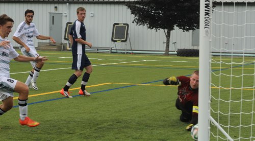 Ball slides by GK Drew Martin into corner as Luis Felipe Delaye (8) looks for rebound