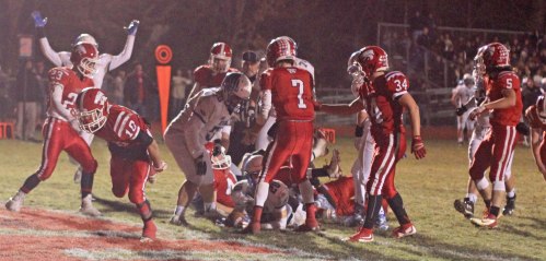 Mike Doyle (on the ground with the ball) reaches the end zone in the first half