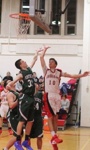 Spencer Pacy (13 points) contests Riley O'Connor's layup attempt