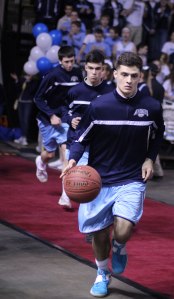 Keenan Hendricks leads the Mariners onto the court