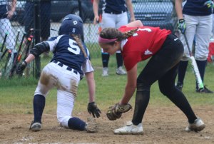 Abby Duggan gets past pitcher Haley Catania scoring the first MA run