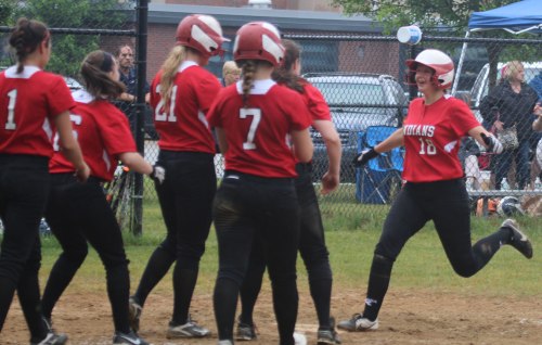 Adrienne Harris greeted by teammates at home after a 2-run homer in the third inning