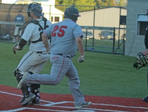 Jacob Albert crosses home with the 3rd Mustangs run