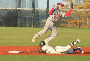 Stefan Strachan slides into second as Trent Spaulding leaps for the throw