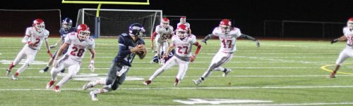 Triton QB Lewi L'Heureux runs for his life on the last play of the game.