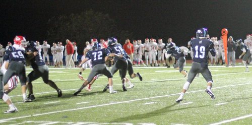 Lewi L'Heureux (19) gets great protection from Kenny Shute (59), John Falasca (72), and Jack McCarthy (58).