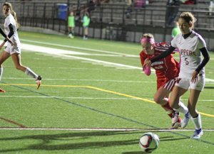 Amelia Kroschwitz (5) tries to get away from Haley Mignon (42)