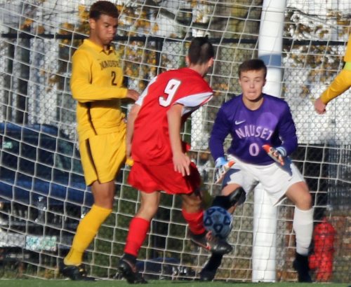 Abdel Talabi (#2) sticks a foot in front of Ben Lockhart's shot as Nauset GK Jack Avellar watches.