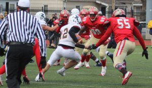 Edward Owuor (89) and Duval Paul (55) converge on scrambling Mattison Cronin