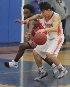 Malik Alston tries to steal the ball from Chris Torres (10 points)