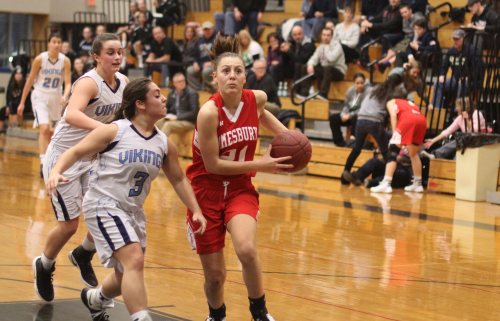 Ali Napoli scores while her sister Maddie checks on spectators.
