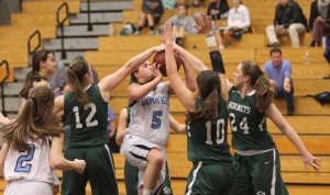 Bridget Sheehan gets her shot blocked by Mel Carter (#12) and Sarah Robinson (#24).